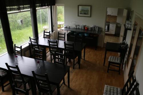 an aerial view of a dining room with tables and chairs at Dettifoss Guesthouse in Skinnastadur