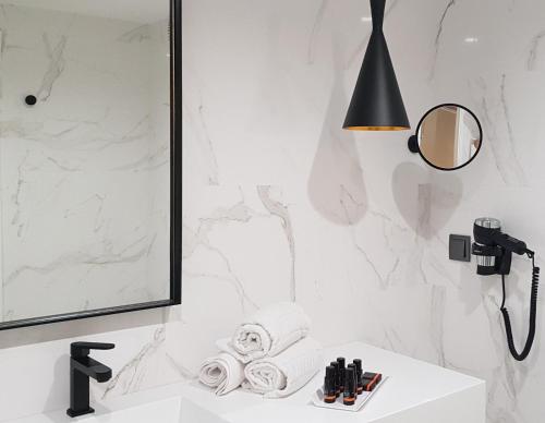 a bathroom with a sink and a mirror at Thomar Boutique Hotel in Tomar