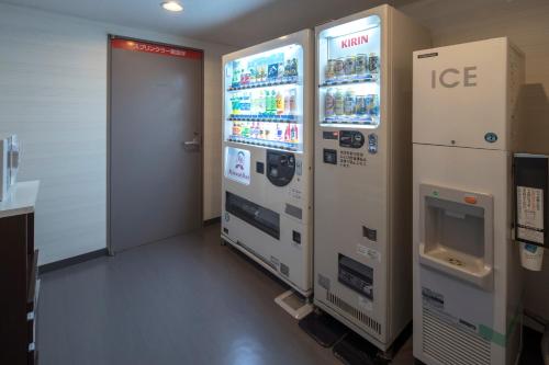 a room with two ice machines and a door at Richmond Hotel Kumamoto Shinshigai in Kumamoto