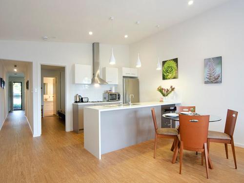 a kitchen and dining room with a table and chairs at Seagrass Villas Normanville in Normanville