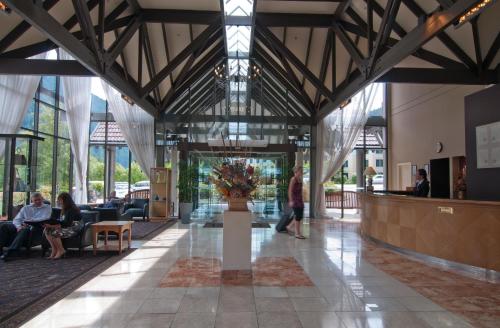 a lobby of a building with people sitting at Copthorne Hotel & Resort Lakefront Queenstown in Queenstown