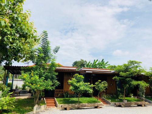 a house with trees in front of it at JJ at Chiangkhan in Chiang Khan