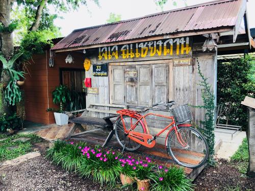 a red bike parked in front of a building at JJ at Chiangkhan in Chiang Khan
