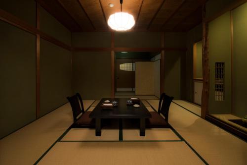 a room with a table and chairs and a light at Yamanoo in Kanazawa