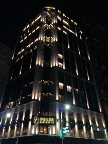 a tall building with lit up windows at night at Harbour 10 Hotel in Kaohsiung