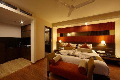 a bedroom with a large bed in a room at Golden Fruits Business Suites in Chennai