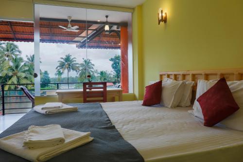 a bedroom with a large bed with towels on it at The Lake Paradise Boutique Resort in Alleppey