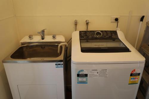 a small kitchen with a sink and a stove at Regent Residential Villa in Whangarei