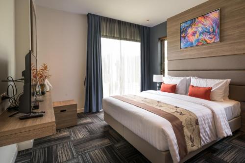 Green Ville Laguna Hotel tesisinde bir odada yatak veya yataklar