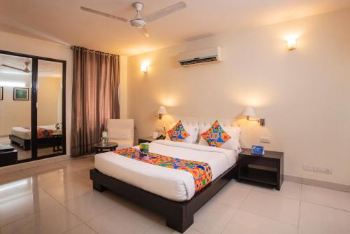 a bedroom with a large bed in a room at FabExpress Anutham Saket in New Delhi