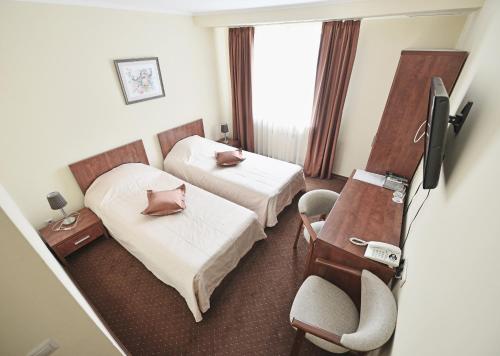 Łóżko lub łóżka w pokoju w obiekcie Gallery Hotel