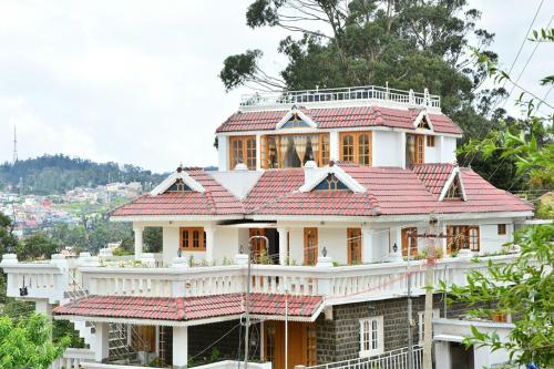 a house with a red roof at Pears Garden Royal Suite in Kodaikānāl