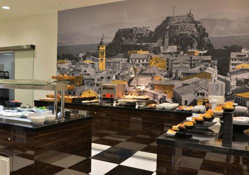 a restaurant with a mural of a city at Rodostamo Hotel & Spa- Adults Friendly in Kommeno
