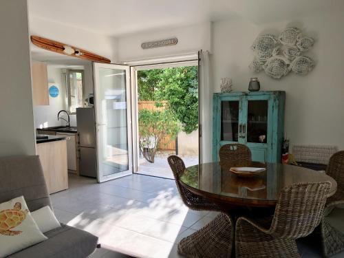 a kitchen and a dining room with a table and chairs at Villa L'Amiraute in Agde