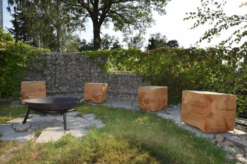 a barbecue grill and wooden boxes in a yard at Charming house@LK-living in Liberec
