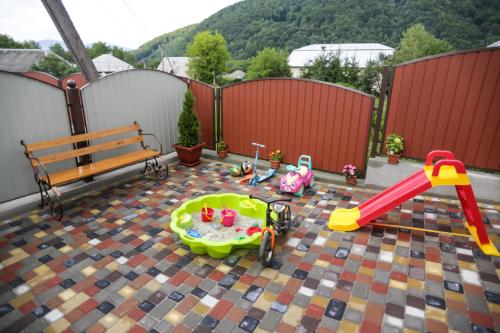 a childs play area with a playground and a bench at U Maksa in Solochyn