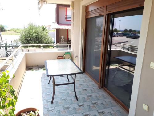 a table on the balcony of a house at New Sea & Sun House in Iraklitsa