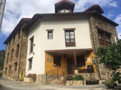 a building with a tower on top of it at Mirador de Enterrias in Enterria
