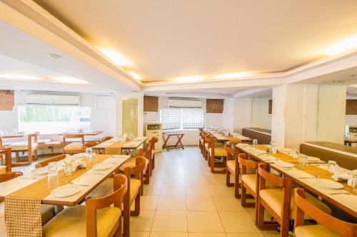 a large dining room with tables and chairs at FabExpress Kalyan in Vadodara