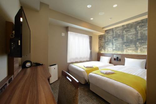 Tempat tidur dalam kamar di Hotel Oriental Express Osaka Shinsaibashi