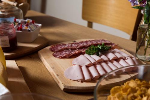 a bunch of meat on a cutting board on a table at Berghotel Chäserstatt in Ernen