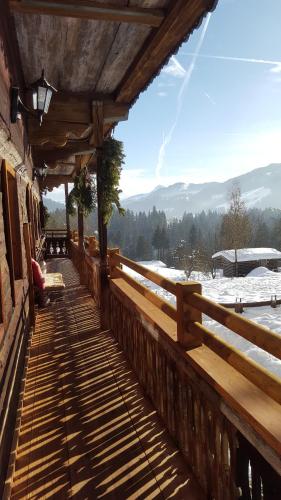 a wooden walkway with snow on the ground at Oberseebachhof in Scheffau am Wilden Kaiser