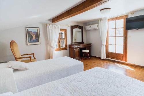 a bedroom with two white beds and a mirror at mas des sentes in Nans-les-Pins