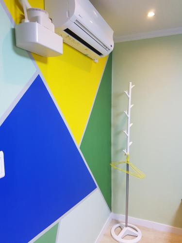 a room with a wall painted with colorful stripes at Seoul Forest Stay in Seoul