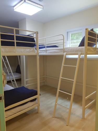 a room with two bunk beds and a window at Seoul Forest Stay in Seoul