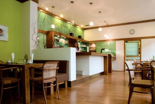 a restaurant with a table and chairs and a bar at Penzion Luna in Brno
