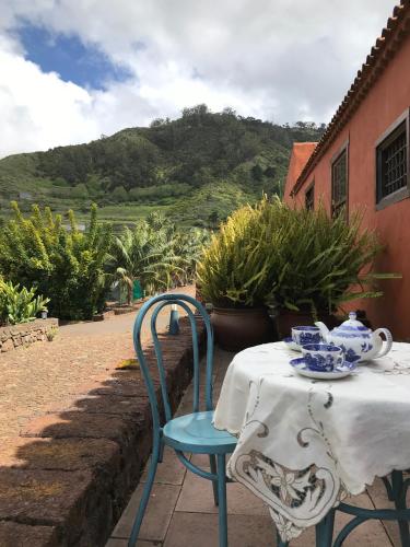 a table with a white table cloth and blue dishes on it at Haciendas del Valle - Las Kentias in Valle de Guerra