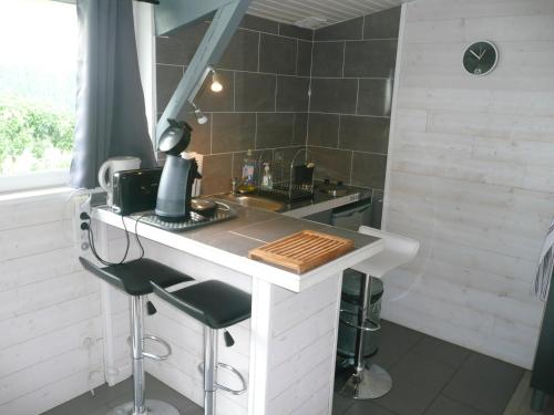 a small kitchen with a counter and a sink at Studio BORDEAUX ST AUGUSTIN in Bordeaux