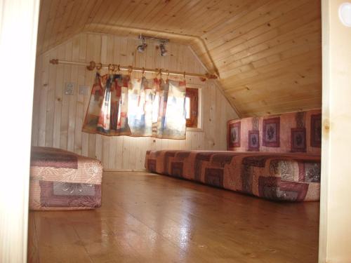 a room with two beds and a window in a cabin at Chaty Dagmar in Liptovský Mikuláš