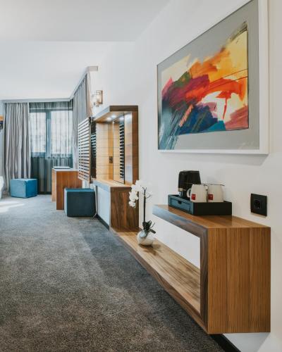 a living room with a large painting on the wall at Boutique Hotel Ani - Adults Only in Makarska