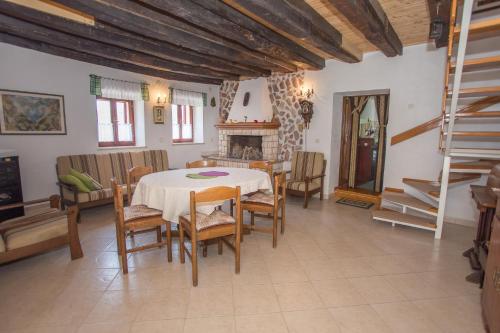 a dining room with a table and chairs and a fireplace at Apartment Romy for 2-4 people with jacuzzi in Motovun