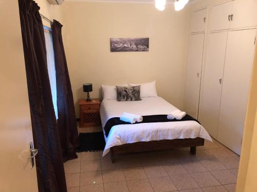 a small bedroom with a bed and a window at Casa Leitao Lodge in Phalaborwa