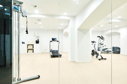 a gym with treadmills and elliptical machines at Eurostars Ibiza in Ibiza Town