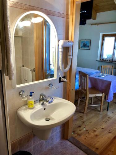 a bathroom with a sink and a mirror at Stella Alpina in Voltago