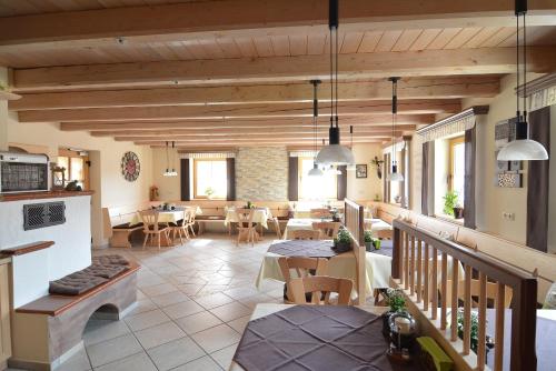 a restaurant with tables and chairs in a building at Pension Weiß in Hohenwarth