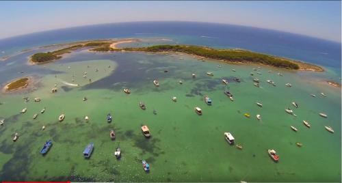 an aerial view of an island with boats in the water at Hotel Riva Del Sole in Porto Cesareo