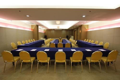 a conference room with a long table and chairs at Baiyoke Suite Hotel in Bangkok