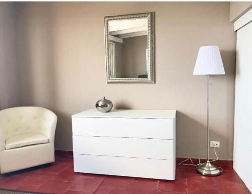 a white toilet sitting in a room next to a window at Nettuno Suite in Syracuse