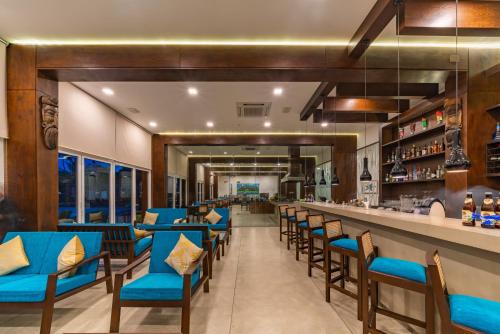 a restaurant with blue chairs and a bar at The Habitat Kosgoda by Asia Leisure in Bentota