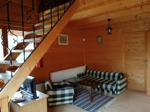 a living room with a couch and a table at Mohás Vendégház Kőszeg Mohás út 107 in Kőszeg