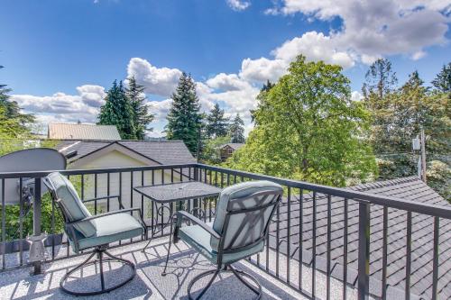 a patio with two chairs and a table on a balcony at Mercer Island- Mt Saint Helens Room in Mercer Island