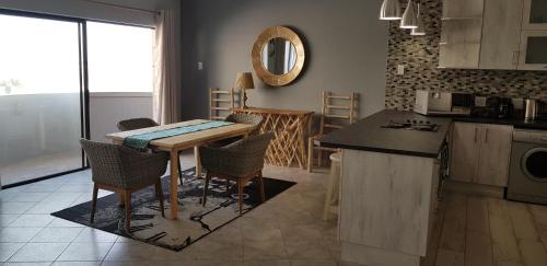 a kitchen with a table and chairs in a room at Vista Mare in Swakopmund