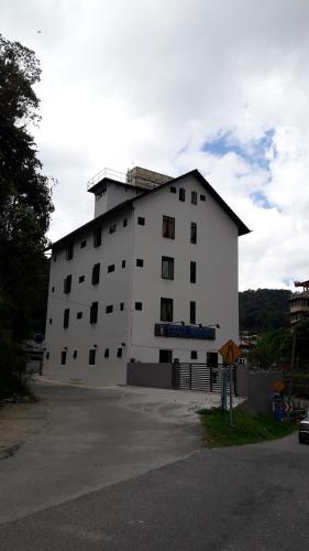 a large white building with a lot of windows at TULIP HOTEL & APARTMENT in Cameron Highlands