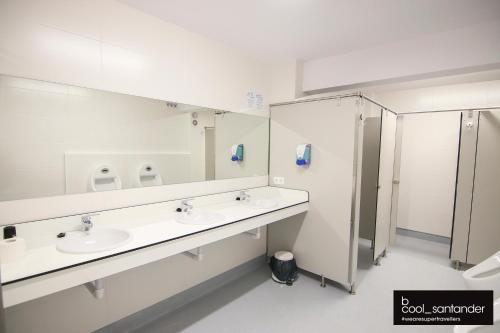 a bathroom with two sinks and a shower at Enjoy Santander in Santander