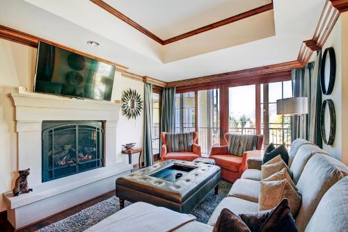 a living room with a couch and a fireplace at Ritz 2Br R208 in Vail