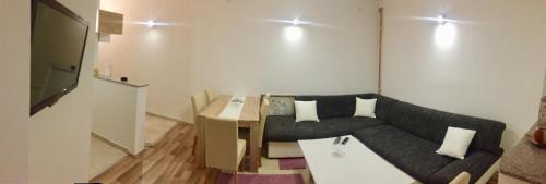 a living room with a couch and a table at Apartman AS in Bihać
